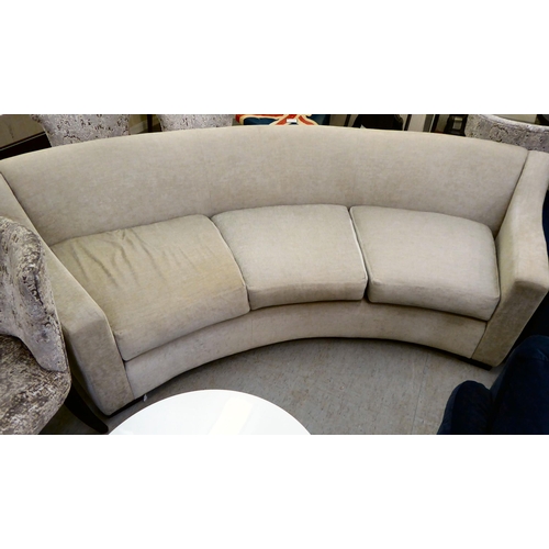 119 - A modern curved, three person settee, upholstered in a cream/Champagne coloured fabric  120