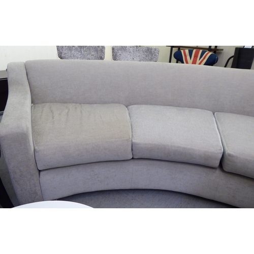 119 - A modern curved, three person settee, upholstered in a cream/Champagne coloured fabric  120