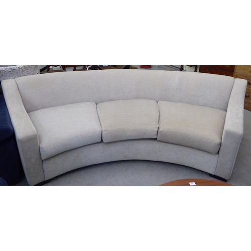 120 - A modern curved, three person settee, upholstered in a cream/Champagne coloured fabric  120