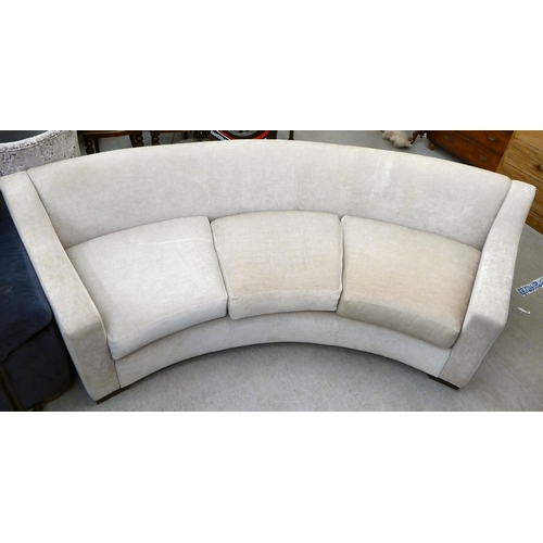 120 - A modern curved, three person settee, upholstered in a cream/Champagne coloured fabric  120