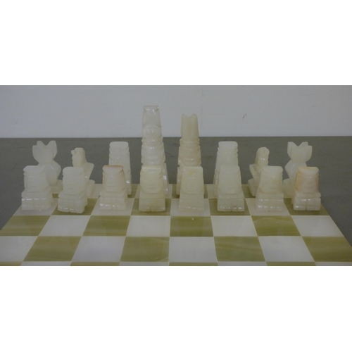 339 - A modern bi-coloured onyx chess set, on a 14