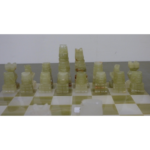 339 - A modern bi-coloured onyx chess set, on a 14