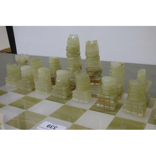 339 - A modern bi-coloured onyx chess set, on a 14