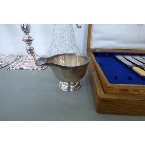 340 - A mixed lot: to include stainless steel teaware; a pair of Georgian style silver plated candlesticks... 