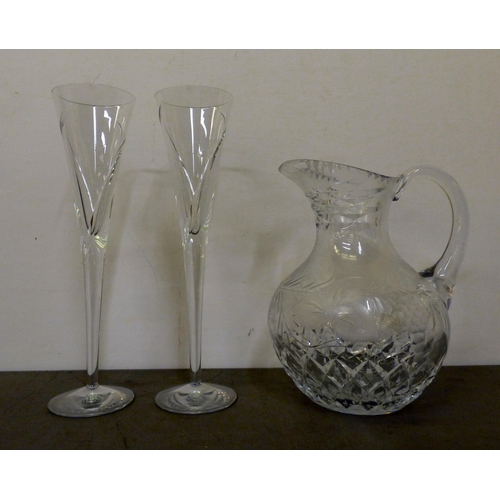 343 - A pair of Waterford crystal Champagne flutes; and a crystal wine jug with engraved fruiting vine dec... 