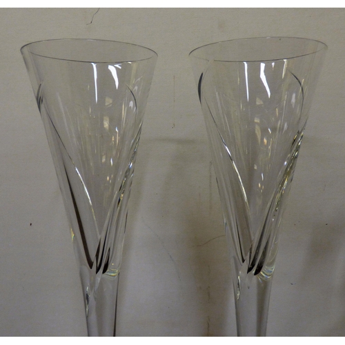 343 - A pair of Waterford crystal Champagne flutes; and a crystal wine jug with engraved fruiting vine dec... 