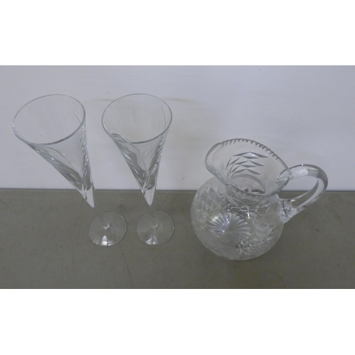 343 - A pair of Waterford crystal Champagne flutes; and a crystal wine jug with engraved fruiting vine dec... 