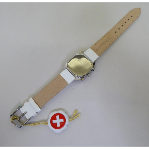 58 - A stainless steel cased Swiss made chronograph, on a white hide strap  cased