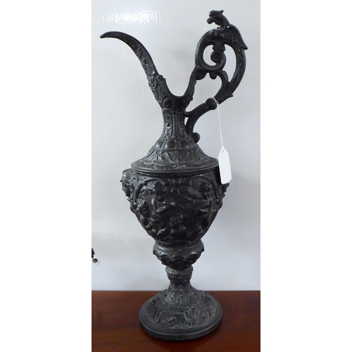 70 - 20thC cast iron items: to include a Continental inspired ewer