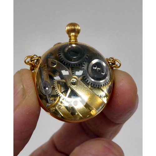 134 - An 18ct gold and glass, ball design watch, faced by an enamelled Roman dial 