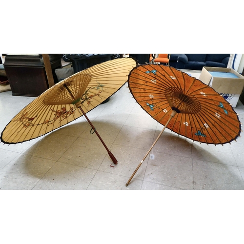 141 - Two 20thC Oriental handpainted paper parasols