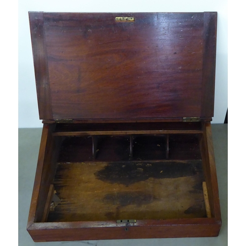 15 - A late Victorian mahogany clerk's desk with a hinged front, enclosing a pigeonhole and open section ... 