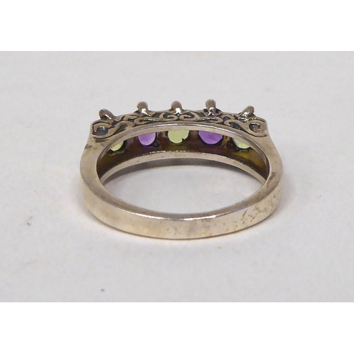 204 - A white metal dress ring, set with amethyst and peridot  stamped 925