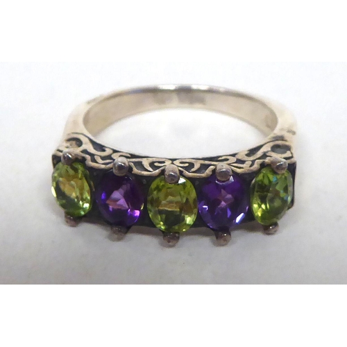 204 - A white metal dress ring, set with amethyst and peridot  stamped 925