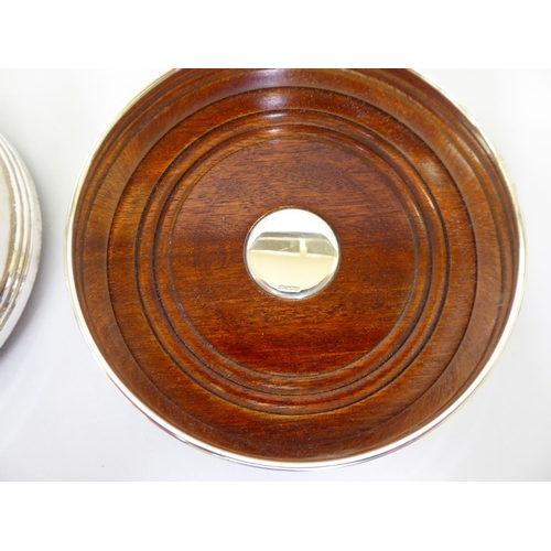 29 - A pair of silver wine coasters, each with a turned mahogany base  Birmingham 1994  5