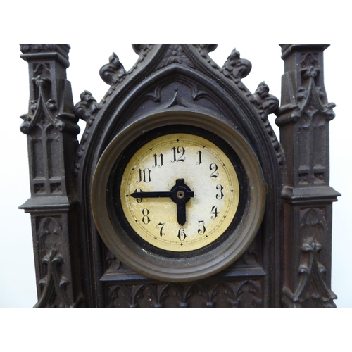 349 - An early 20thC cast iron Gothic Cathedral inspired, cased mantel timepiece; the modern movement face... 