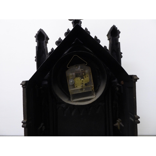 349 - An early 20thC cast iron Gothic Cathedral inspired, cased mantel timepiece; the modern movement face... 