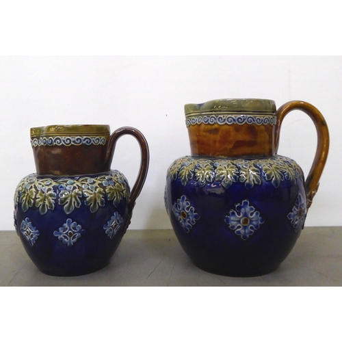 39 - Two Royal Doulton stoneware jugs, decorated with foliage  5.5