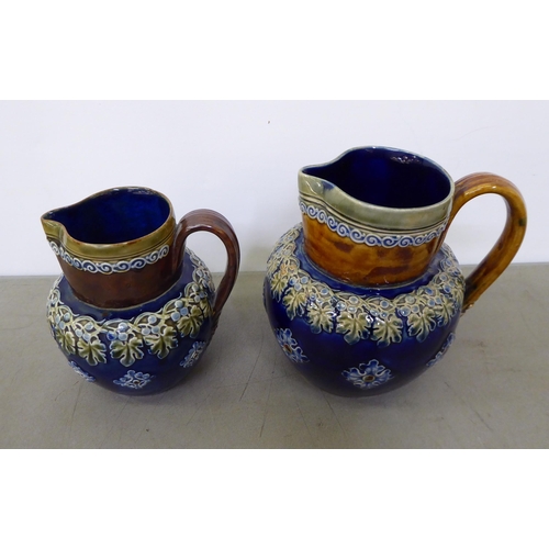 39 - Two Royal Doulton stoneware jugs, decorated with foliage  5.5