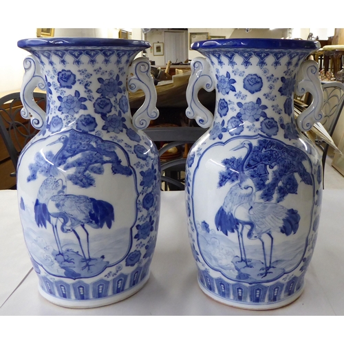 53 - A pair of modern Chinese porcelain vases, decorated in blue and white with cranes and flora  14... 