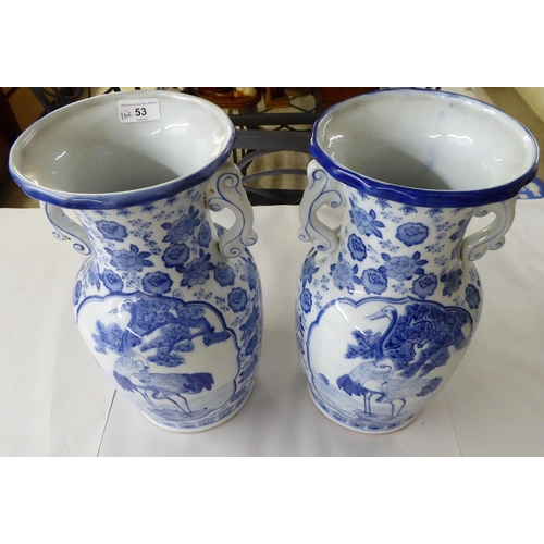 53 - A pair of modern Chinese porcelain vases, decorated in blue and white with cranes and flora  14... 