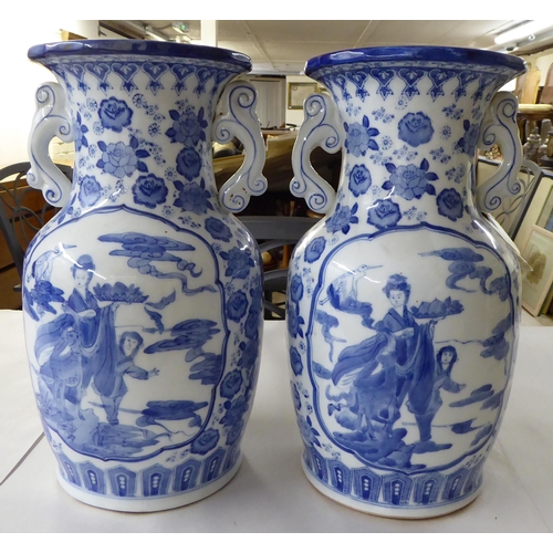 53 - A pair of modern Chinese porcelain vases, decorated in blue and white with cranes and flora  14... 