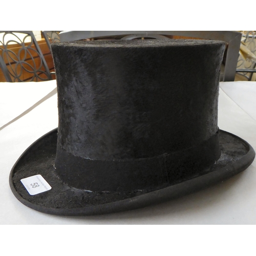 58 - A Meldrums of Aberdeen black silk and fabric covered top hat, internal dimensions front to back 8