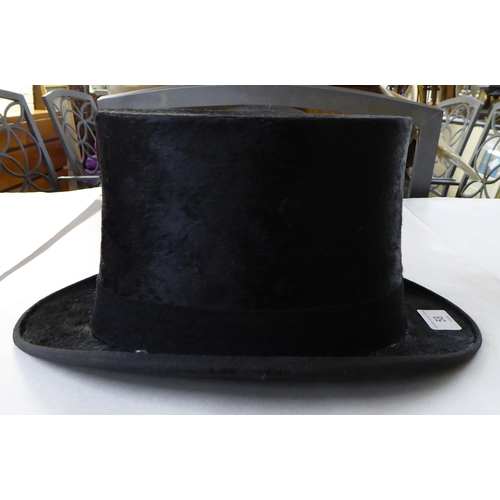 58 - A Meldrums of Aberdeen black silk and fabric covered top hat, internal dimensions front to back 8