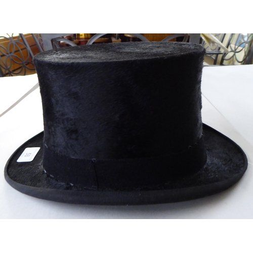 58 - A Meldrums of Aberdeen black silk and fabric covered top hat, internal dimensions front to back 8