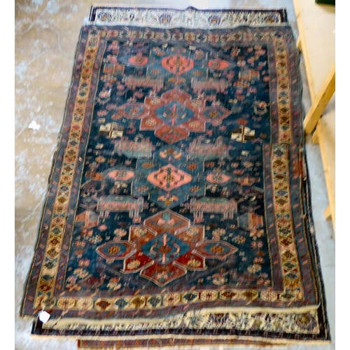 59 - Four dissimilar Persian and similar rugs, each individually decorated on multi-coloured grounds ... 