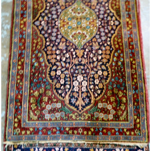 59 - Four dissimilar Persian and similar rugs, each individually decorated on multi-coloured grounds ... 