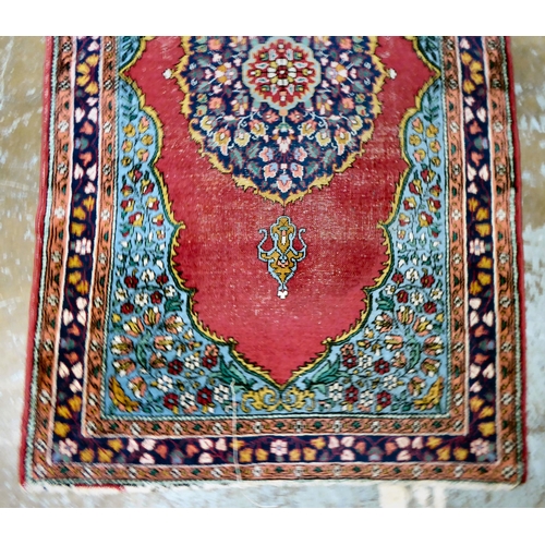 59 - Four dissimilar Persian and similar rugs, each individually decorated on multi-coloured grounds ... 