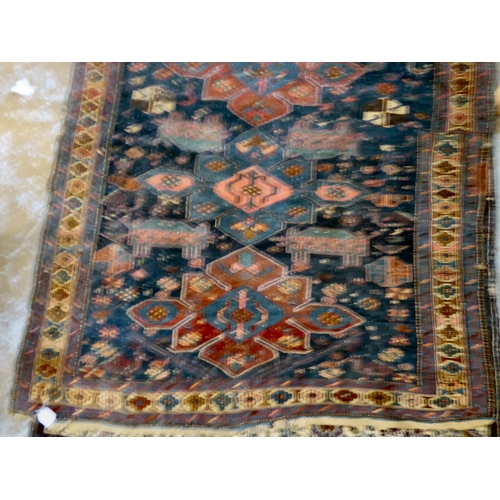 59 - Four dissimilar Persian and similar rugs, each individually decorated on multi-coloured grounds ... 