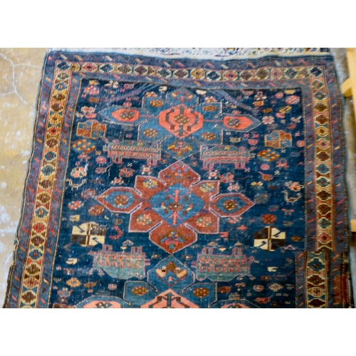 59 - Four dissimilar Persian and similar rugs, each individually decorated on multi-coloured grounds ... 