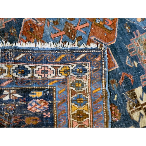 59 - Four dissimilar Persian and similar rugs, each individually decorated on multi-coloured grounds ... 