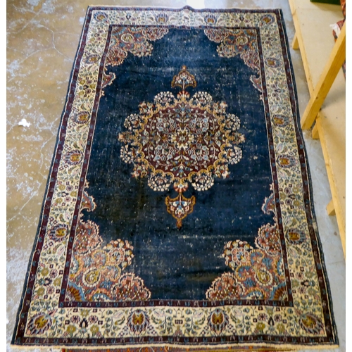 59 - Four dissimilar Persian and similar rugs, each individually decorated on multi-coloured grounds ... 