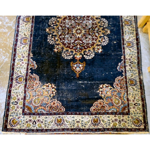 59 - Four dissimilar Persian and similar rugs, each individually decorated on multi-coloured grounds ... 