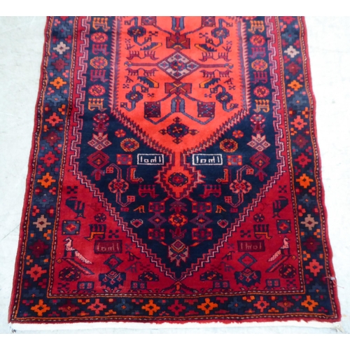 61 - A Shiraz rug, on a red ground  42