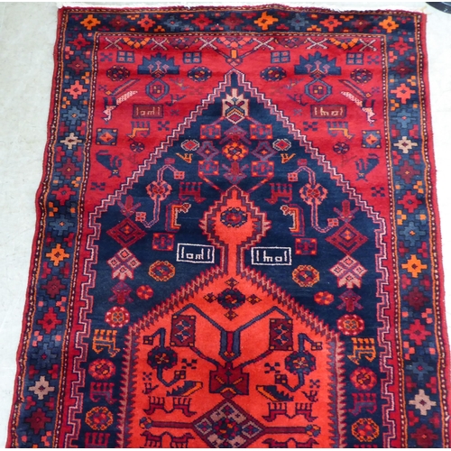 61 - A Shiraz rug, on a red ground  42