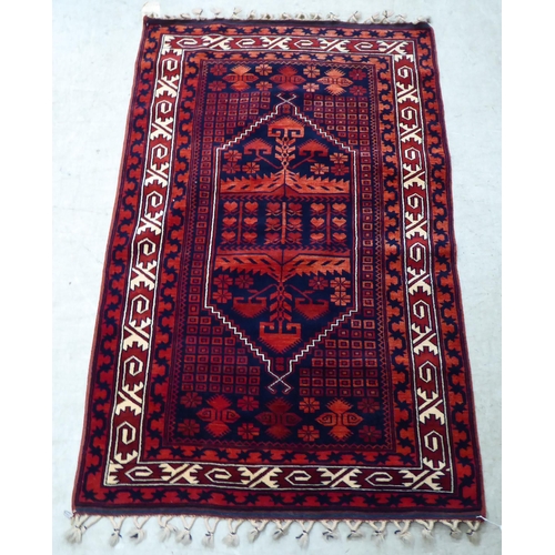 64 - A Turkish rug, on a red ground  44