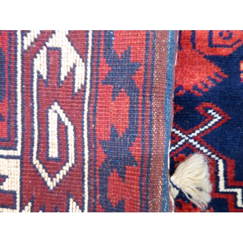 64 - A Turkish rug, on a red ground  44