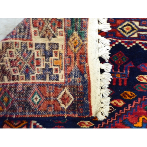 65 - A Kurdish style rug, decorated with four hexagonal motifs, on a multi-coloured ground  46