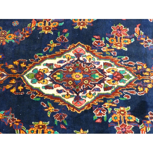 66 - A Hamadan design rug, decorated with floral motifs and a central medallion, on a navy blue ground&nb... 