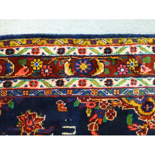 66 - A Hamadan design rug, decorated with floral motifs and a central medallion, on a navy blue ground&nb... 