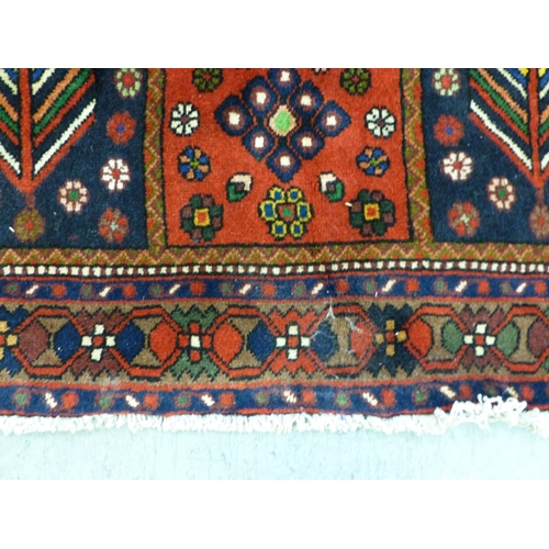 73 - A Bakhtiari design rug, decorated with a chequerboard of floral and geometric motifs, on a multi-col... 