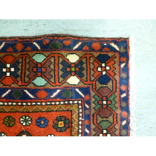 73 - A Bakhtiari design rug, decorated with a chequerboard of floral and geometric motifs, on a multi-col... 