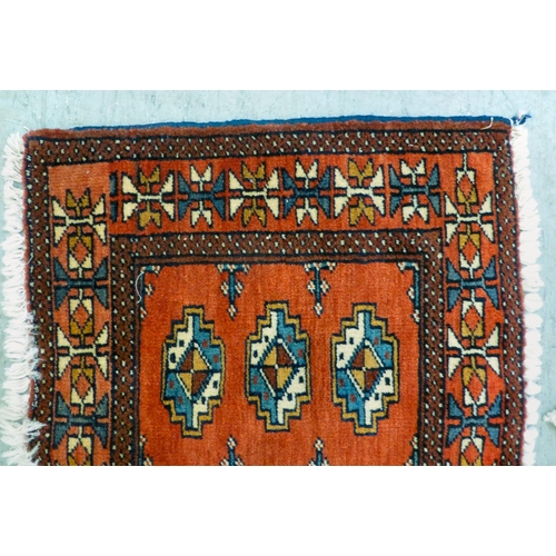 80 - Two Persian rugs, one decorated with floral designs, on a blue ground  24