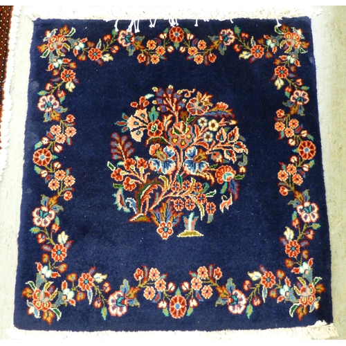 80 - Two Persian rugs, one decorated with floral designs, on a blue ground  24