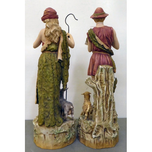 12 - Two Royal Dux figures, viz. a shepherd and shepherdess with sheep  each 15