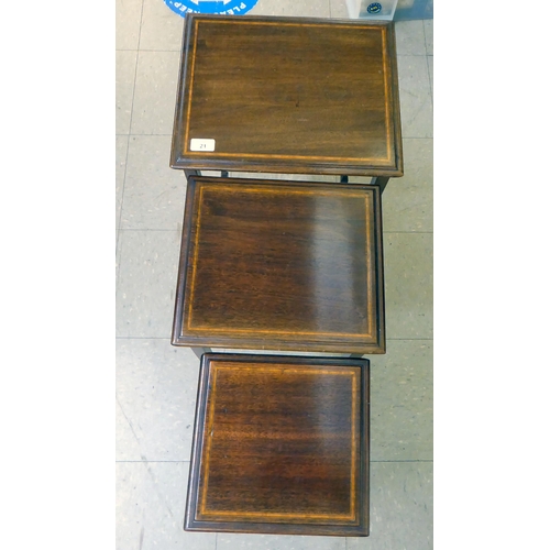 21 - A nesting set of three ebony and string inlaid, mahogany occasional tables, raised on square, tapere... 